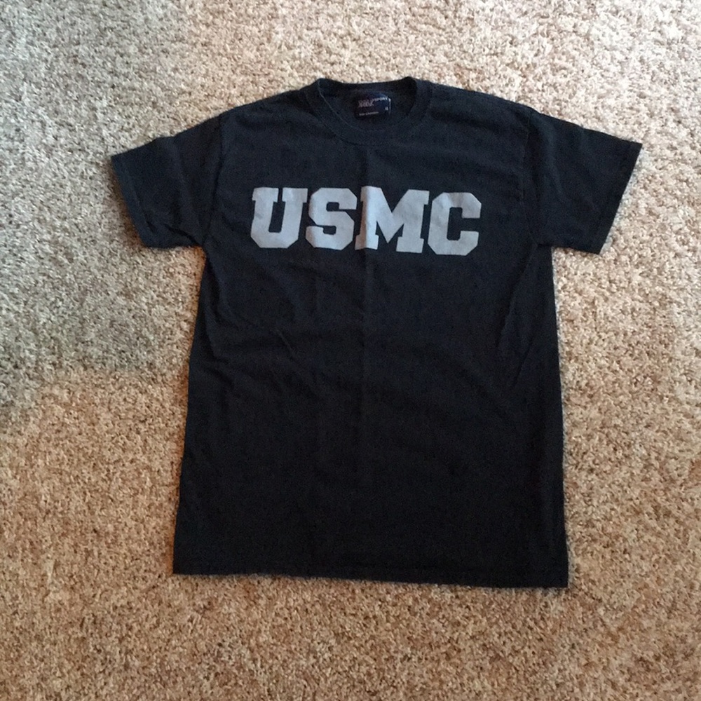 A black shirt with USMC logo